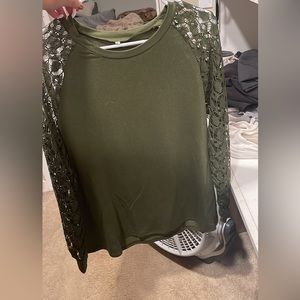 Green long sleeve shirt with open designs on the sleeves